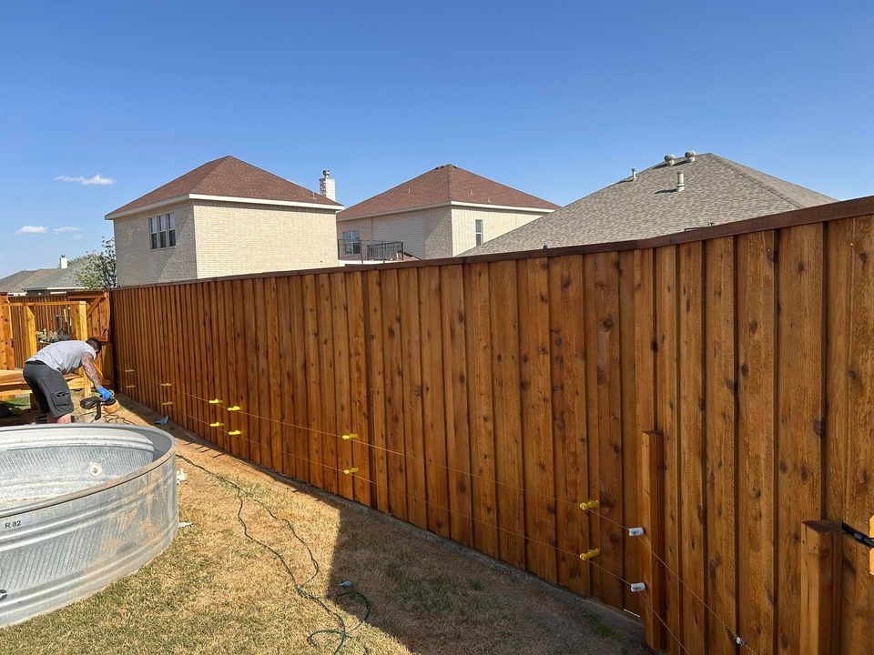 Wood privacy fence along a residential yard.